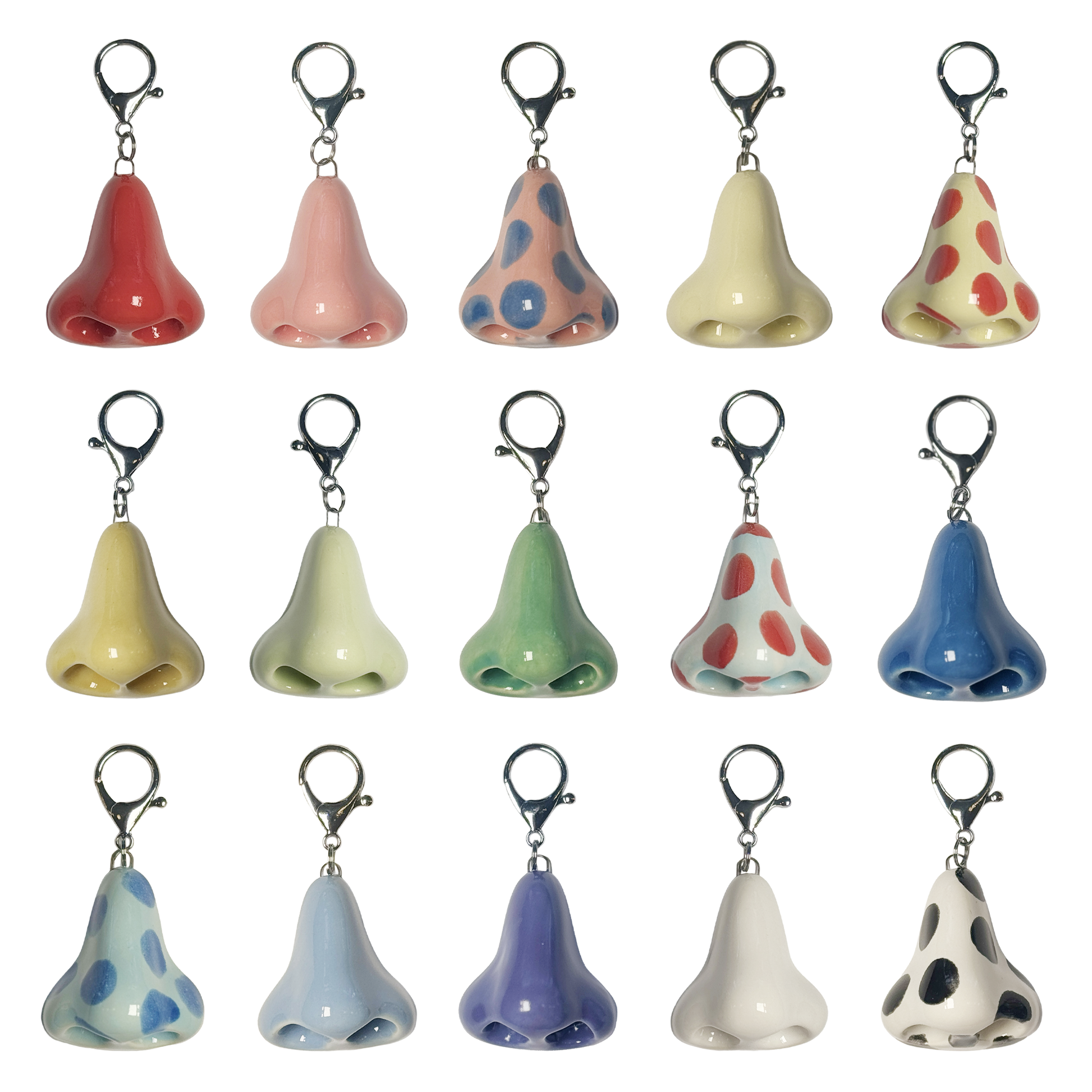 Set of colorful ceramic nose-shaped keychains on a white background
