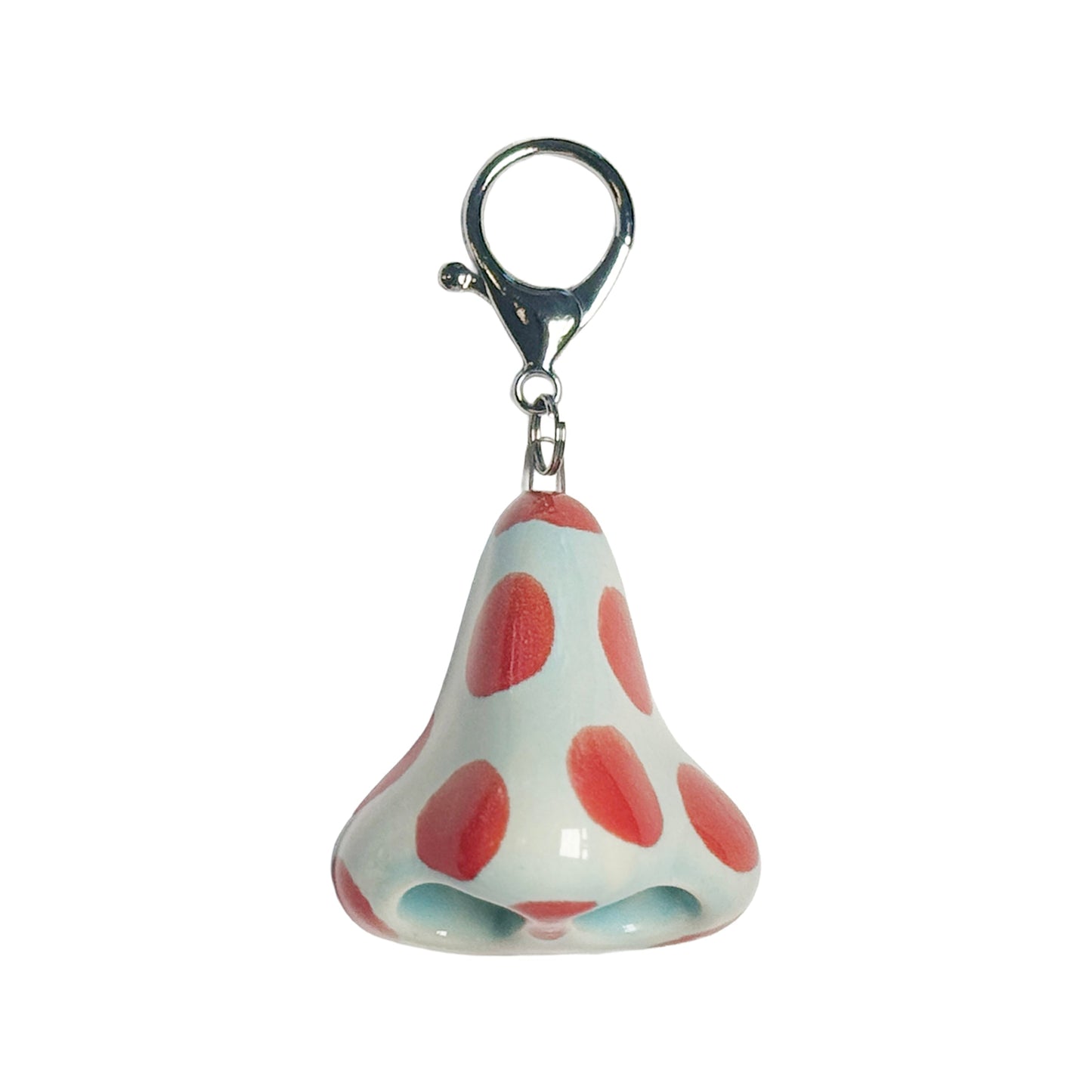 Keychain with a design resembling a nose with red spots on a white background